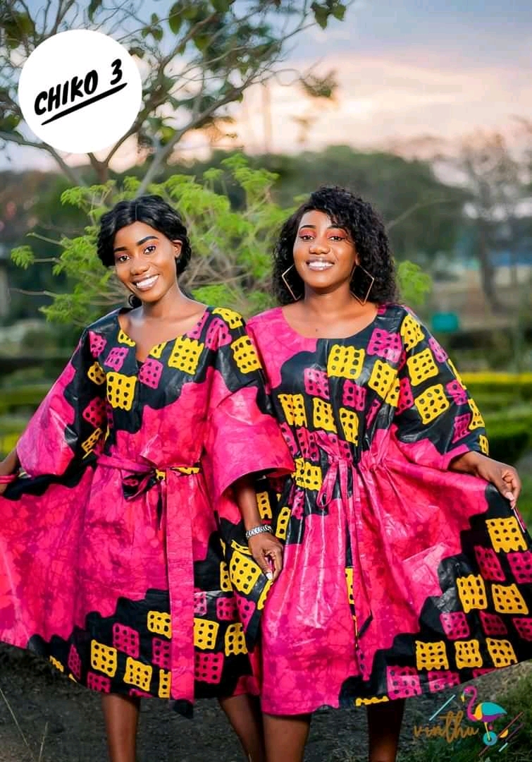 Two women standing together outdoors in matching patterned outfits